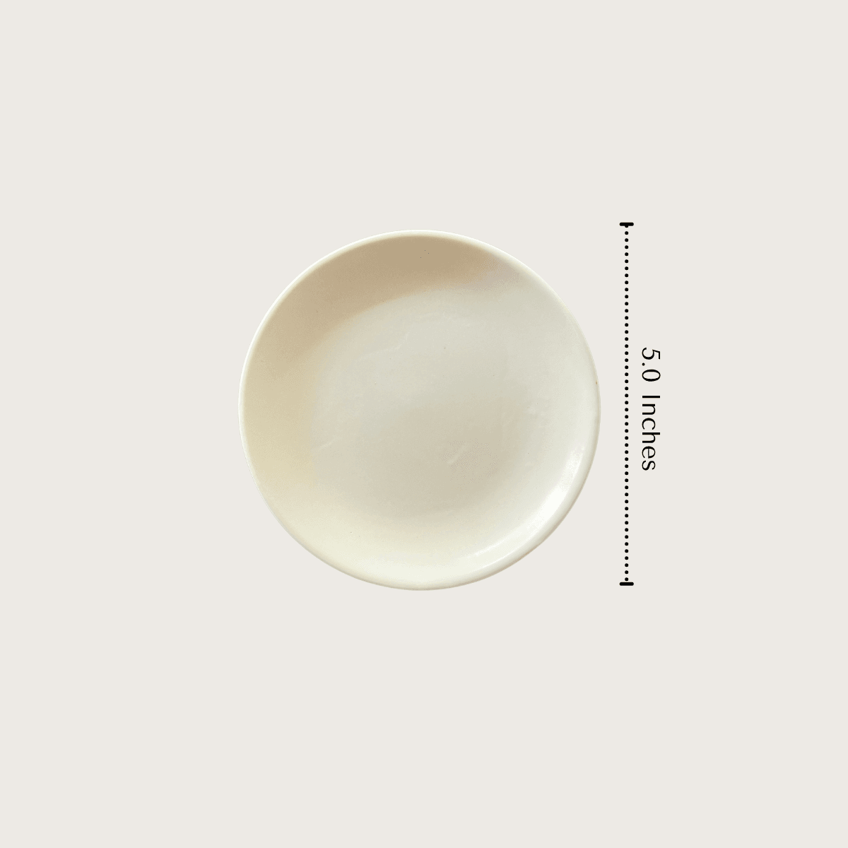 Top-down view of the 5-inch Ivory Petite Plate showing its compact size and shallow 0.6-inch rim height, perfectly scaled as a tea bag rest or pastry saucer.