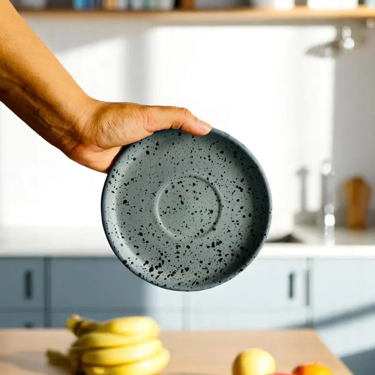Small 6-inch snack plate held by hand; the perfect size for tea-time biscuits or a side of fruit..