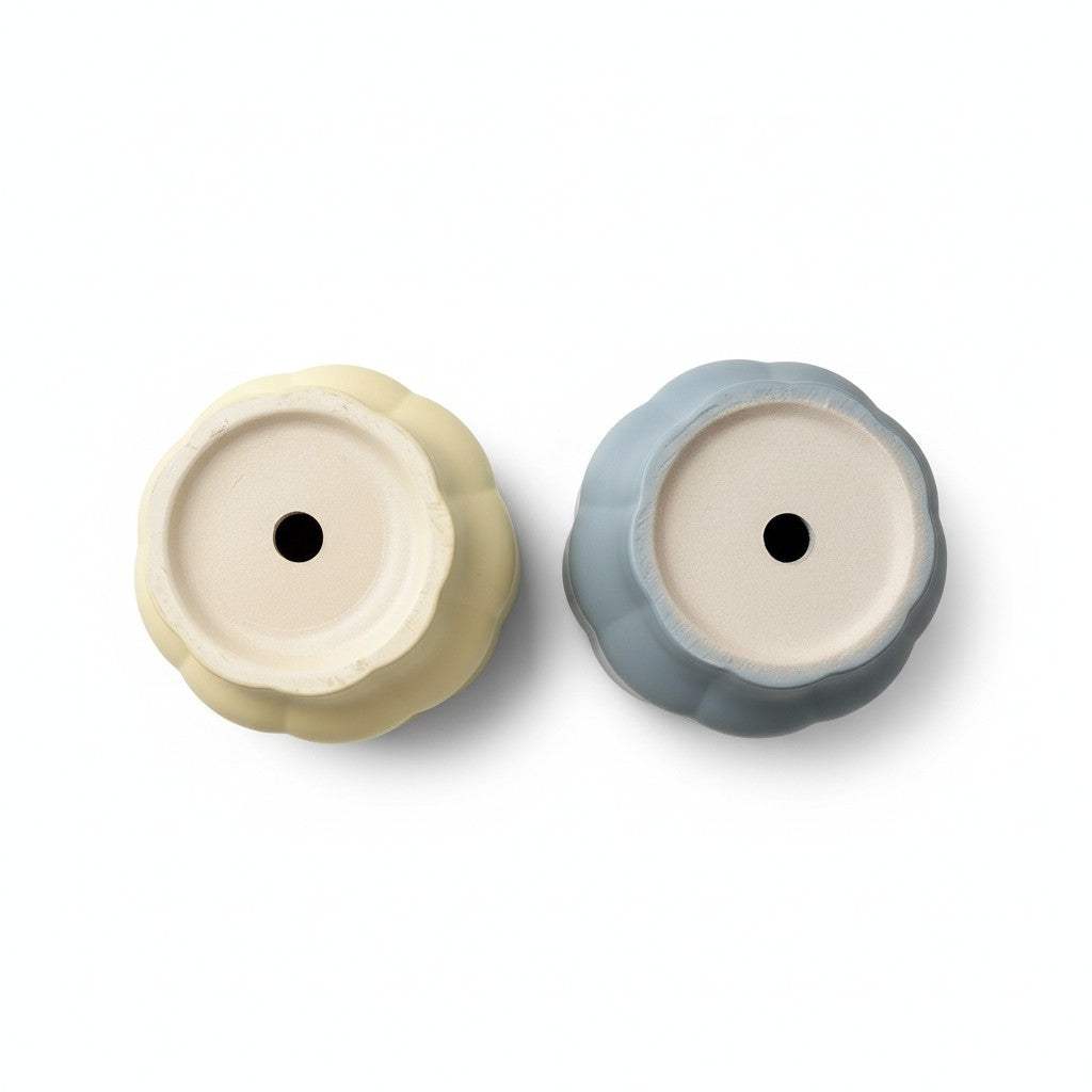 Two ceramic planters showing drainage holes for healthy roots.