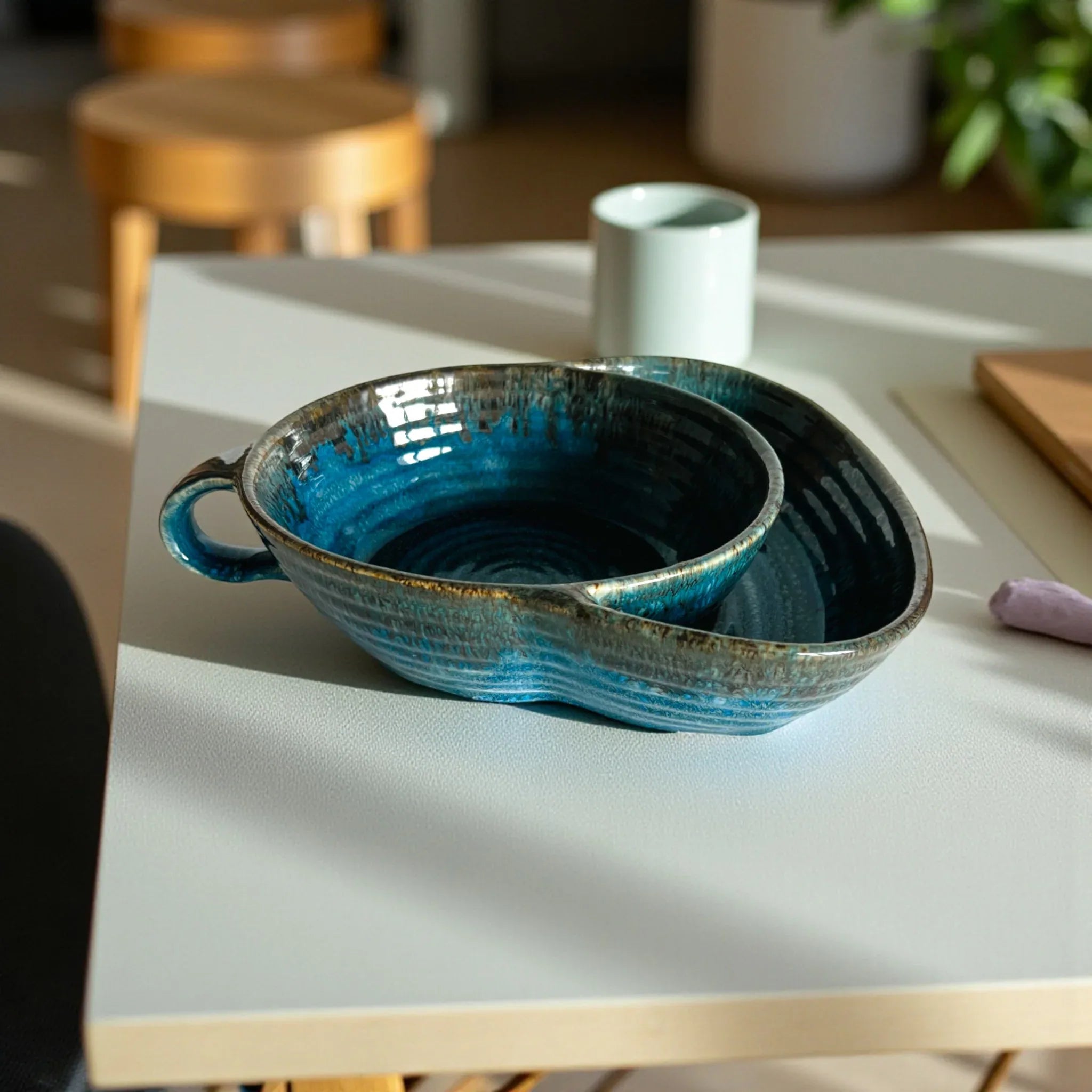 Blue chip and dip ceramic bowl on a light-colored surface with a blurred background