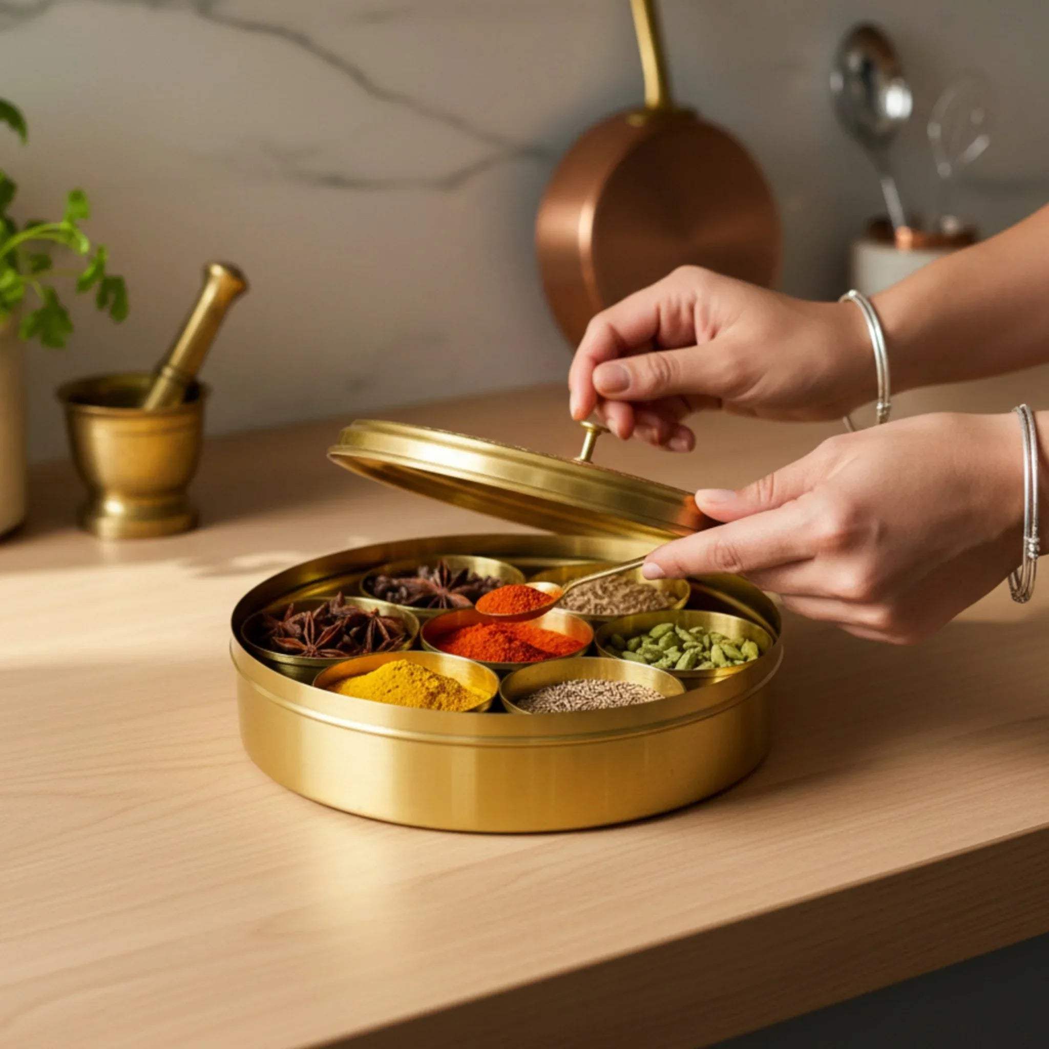 Brass Masala Orb on a kitchen counter; Pinterest-worthy luxury spice organization and aesthetic pantry styling.