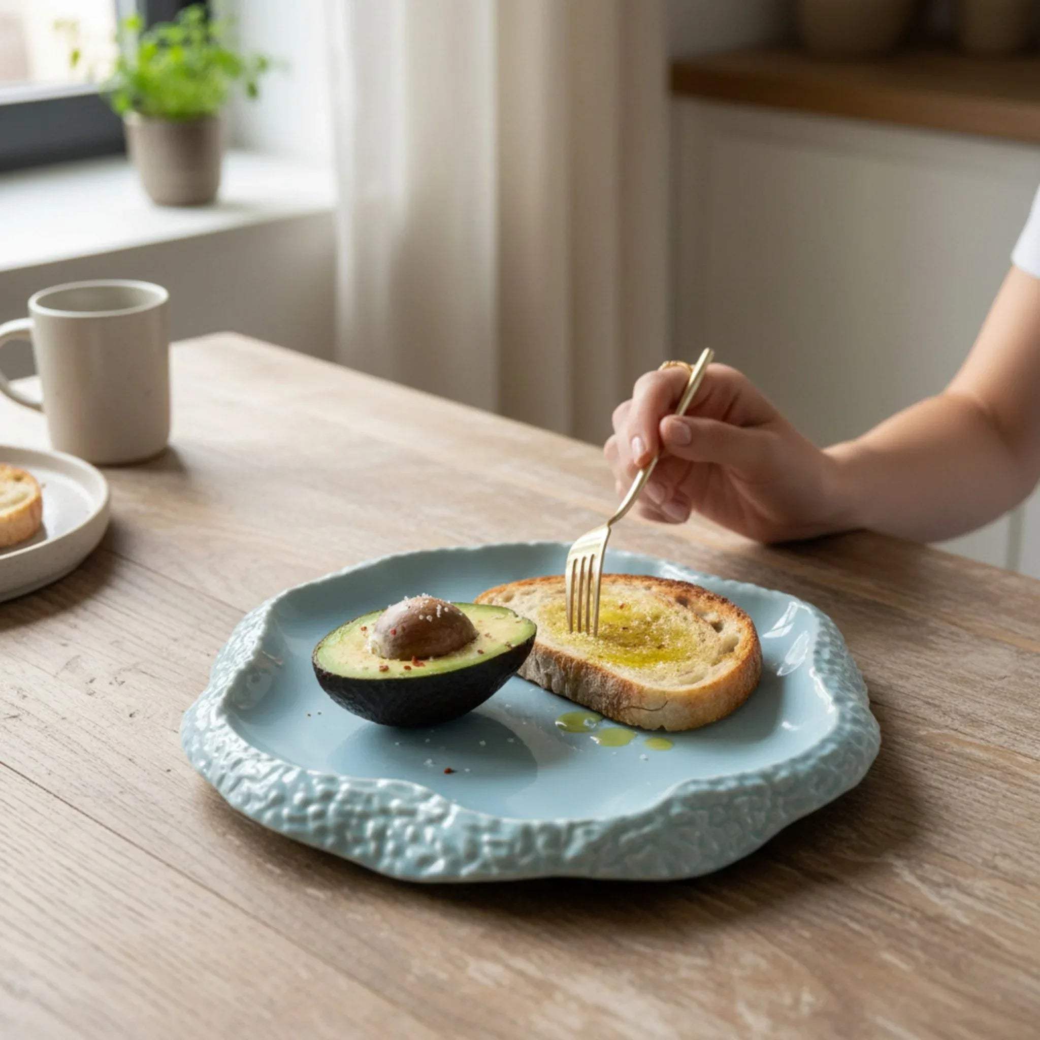 Breakfast setup; the seafoam plate served with avocado and toast.