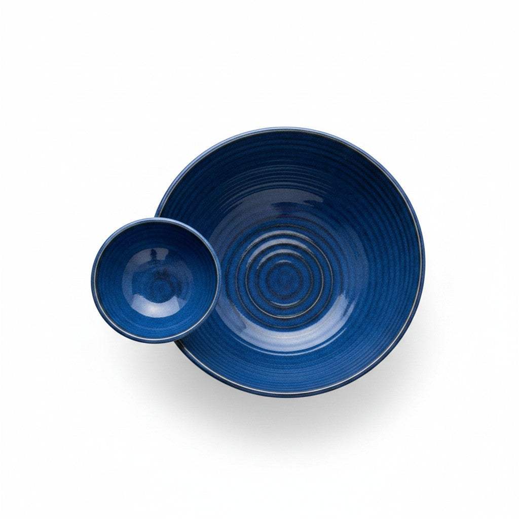 Close-up view of the seamless integrated center dip section on the glossy blue stoneware serving bowl.