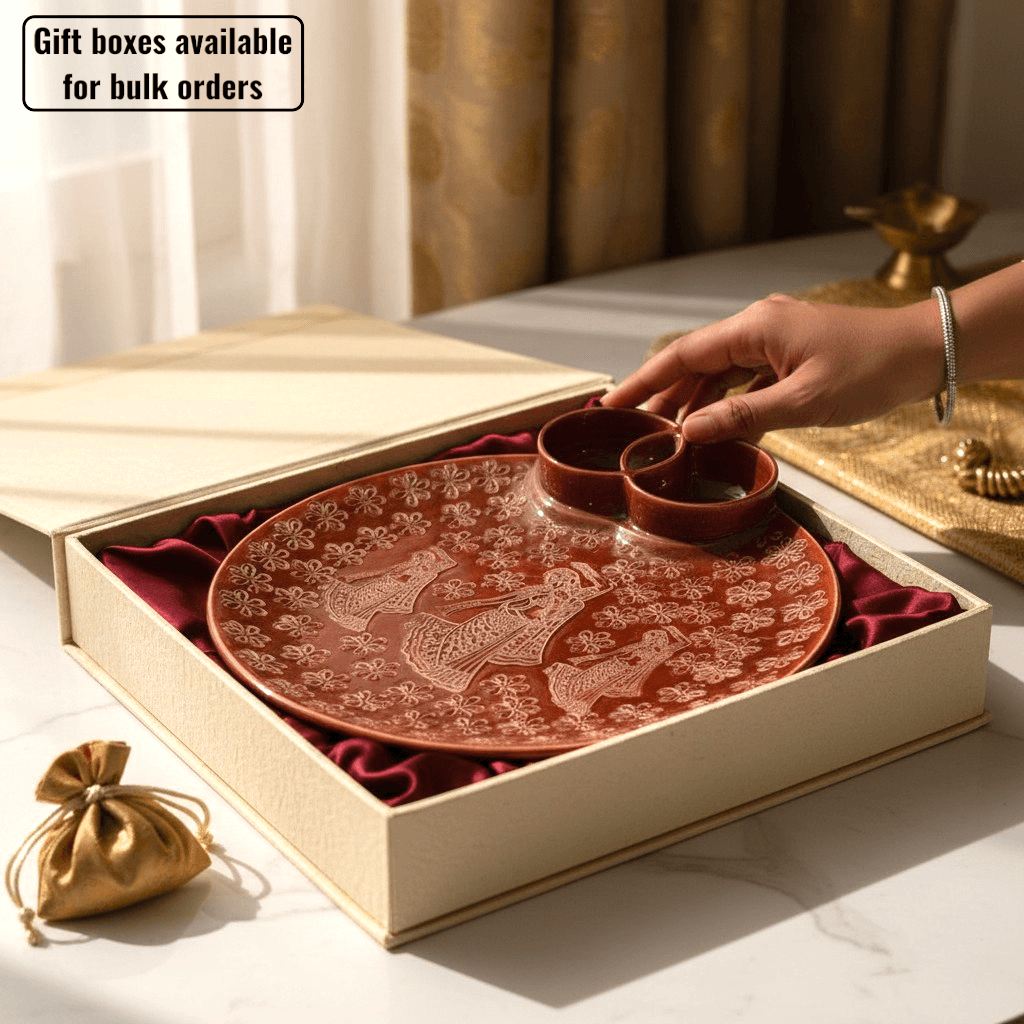 Close-up view of the built-in dual compartment dip section on the terracotta red stoneware serving plate in a gift box.