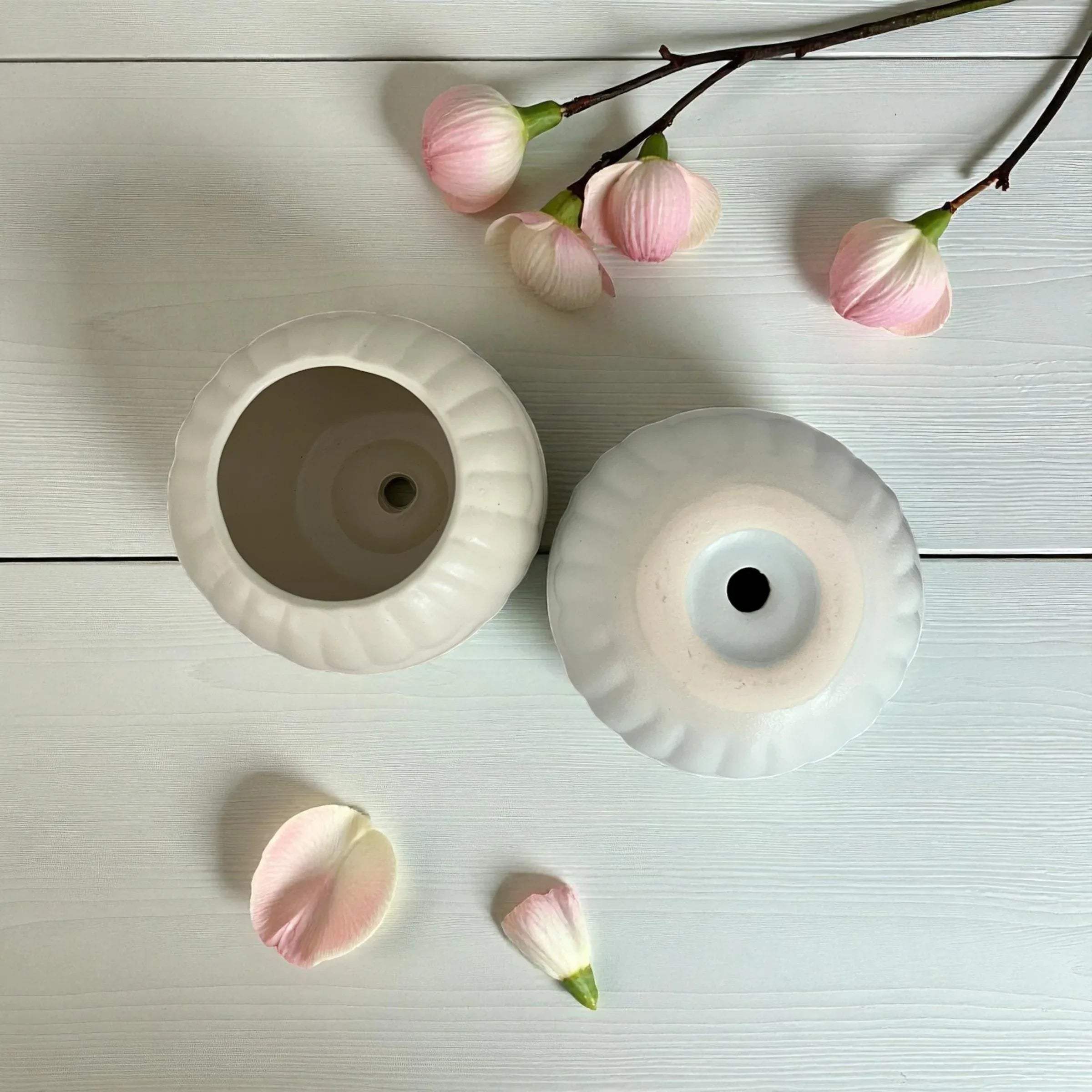Soft wavy cloud texture; matte white and blue ceramic finish showing drainage holes; artisanal pottery for mood boards.