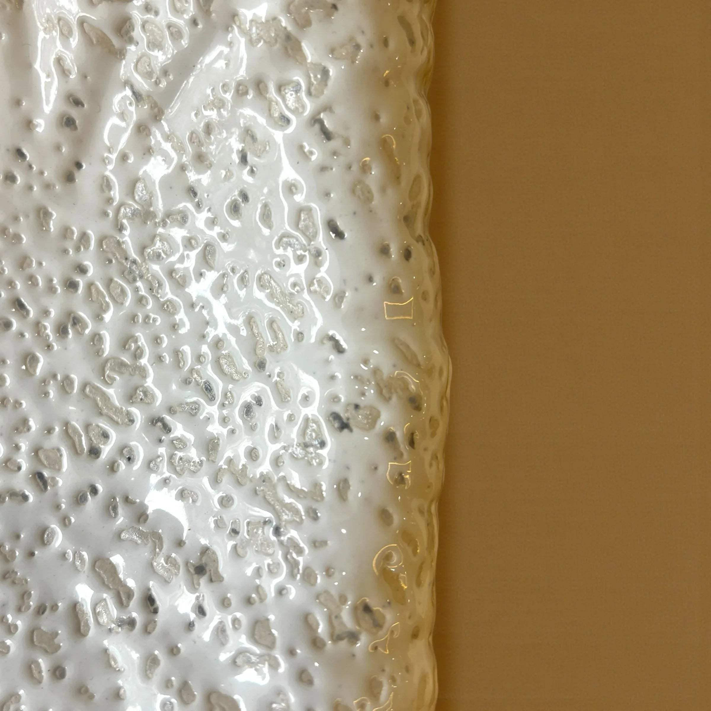 Soft undulating platter edges; matte white ceramic finish and artisanal pottery craft for mood boards.