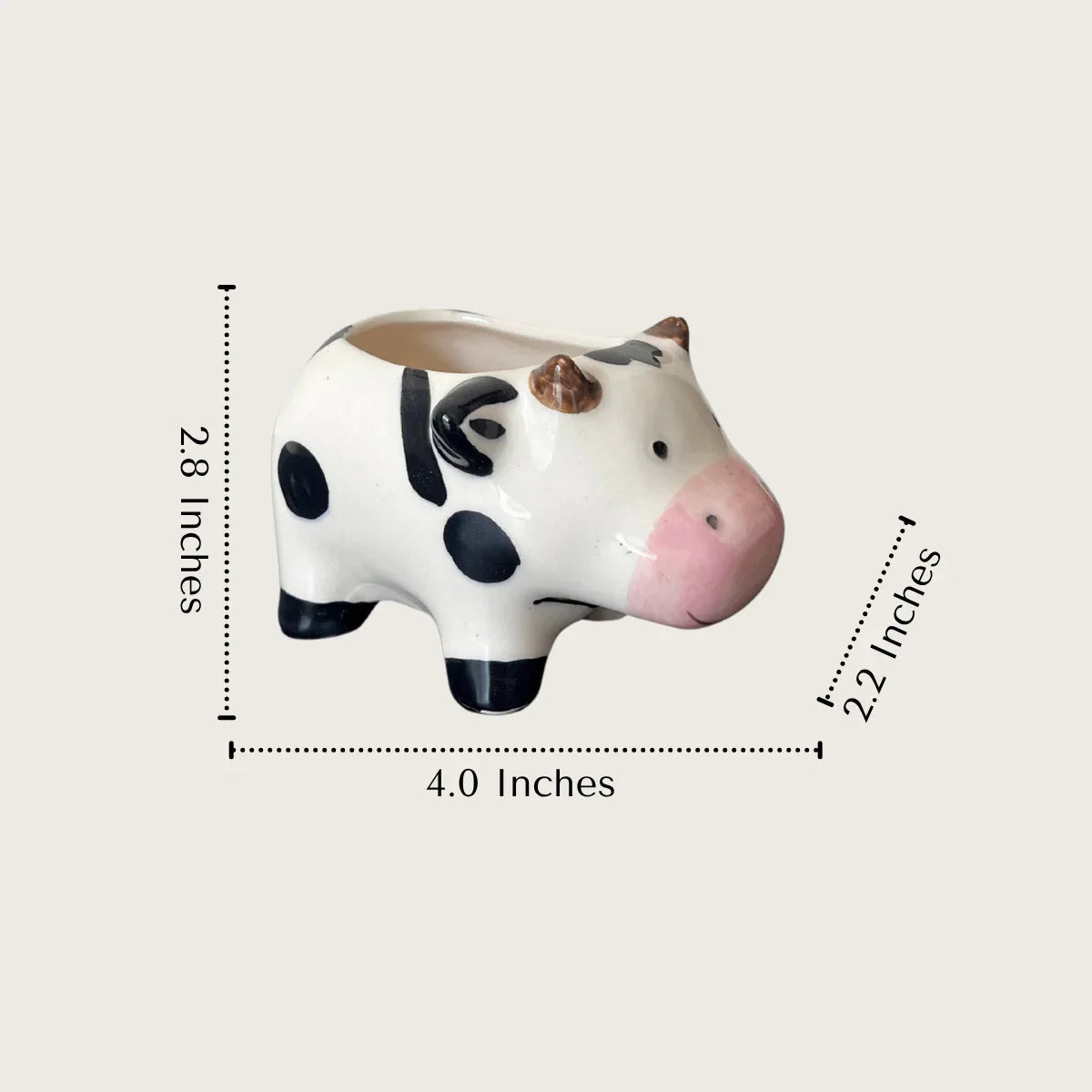 Ceramic cow-shaped planter with measurements.