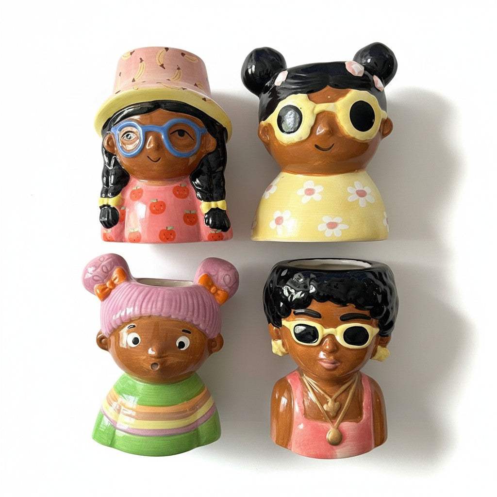 Close-up view of the smooth glossy finish and hand-painted retro glasses details on the mini ceramic bust planters.