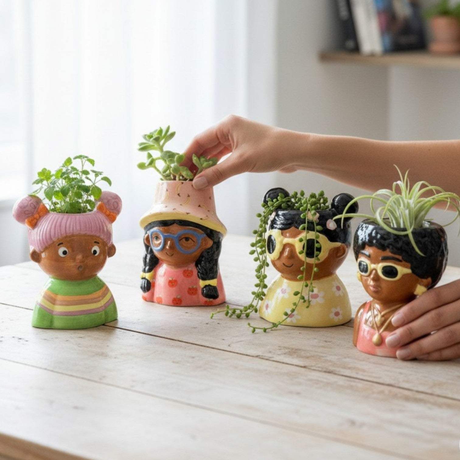 The Misfit set of four colourful ceramic girls pots arranged together as an eclectic gifting option for your girl gang.