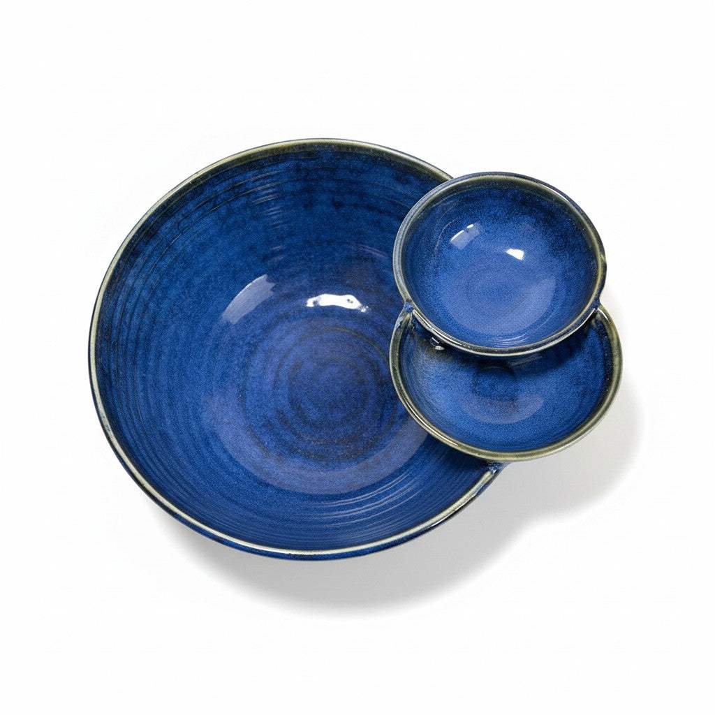 Close-up of the two seamless built-in side dip compartments on the deep blue ceramic serving bowl.