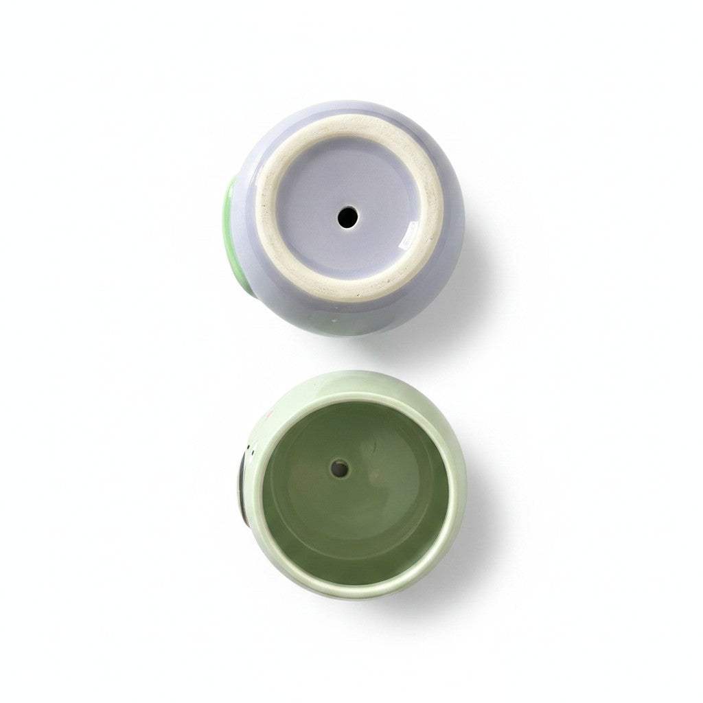 Bottom view showcasing the drainage hole design of the ceramic animal planters for root health.