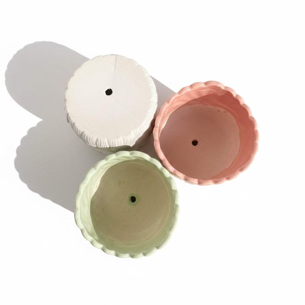 Bottom view highlighting the drainage hole design of the pastel ceramic flower pots for better root health.
