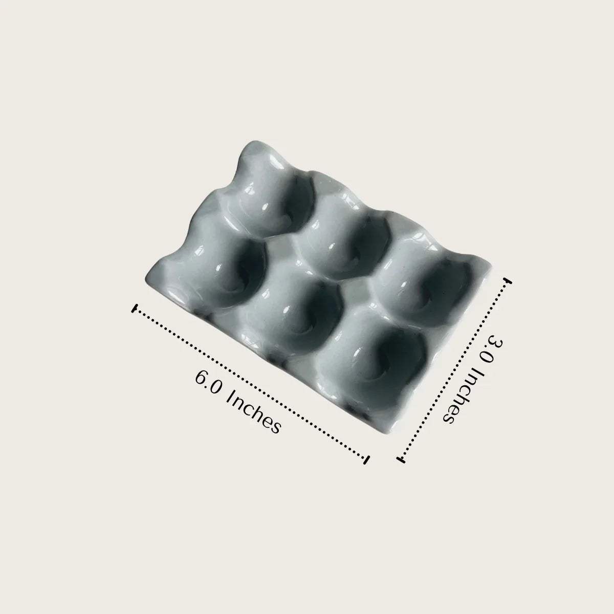 Egg Affair size; 6-inch by 3-inch ceramic tray with 6 deep slots for standard and jumbo-sized eggs.
