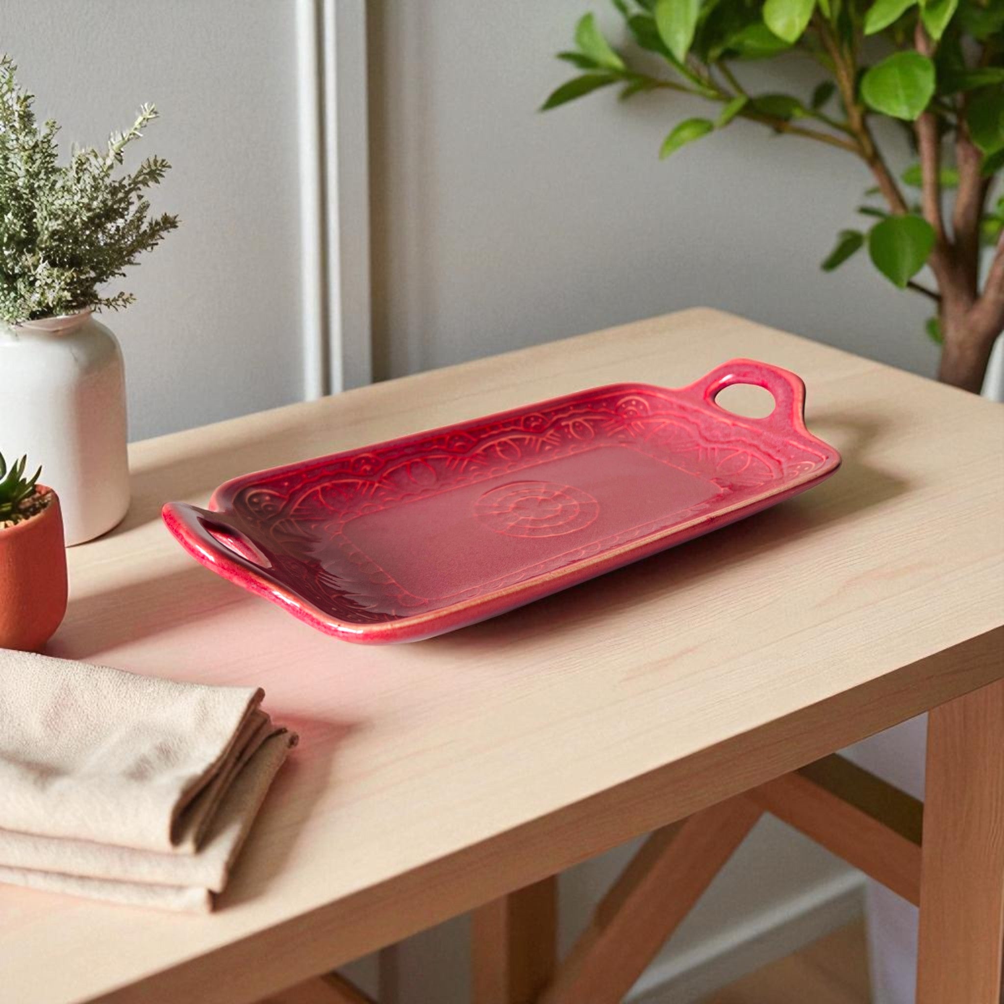 Embossed border detail; rich berry-pink glaze and handcrafted ceramic handle texture for mood boards.