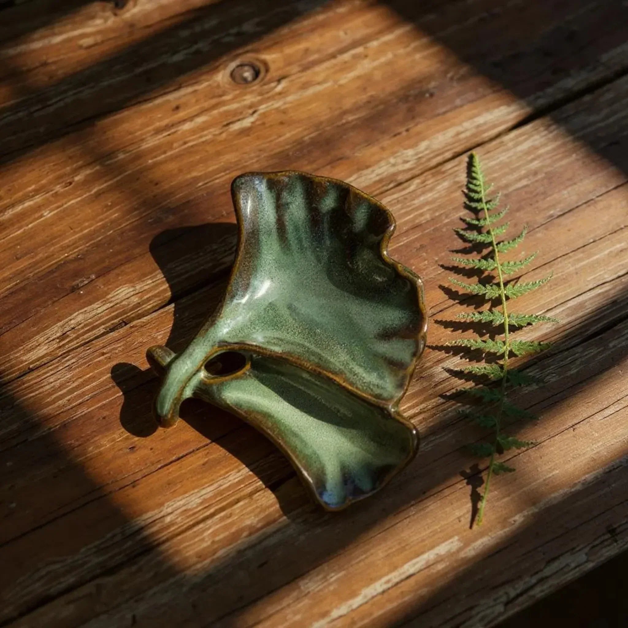 Green Ginkgo Holder next to a leaf; petite size for rings, earrings, or as a sophisticated salt cellar.