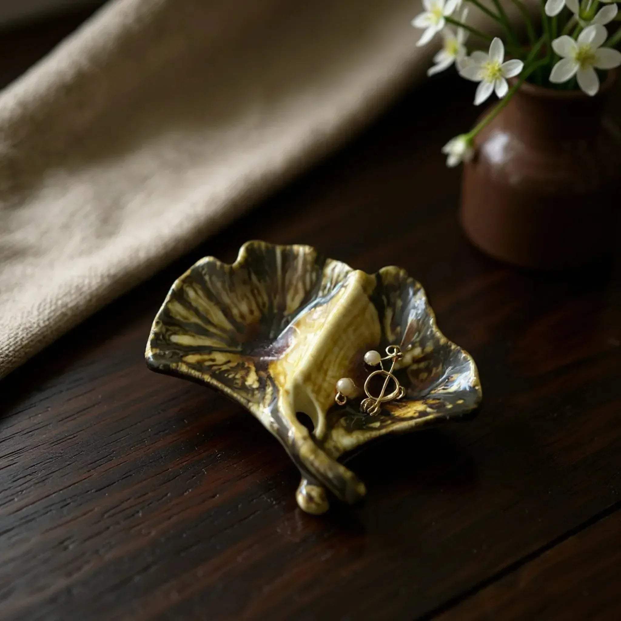 Ginkgo Holders with rings; Pinterest-worthy bedside table styling and aesthetic gold trinket dish photography.