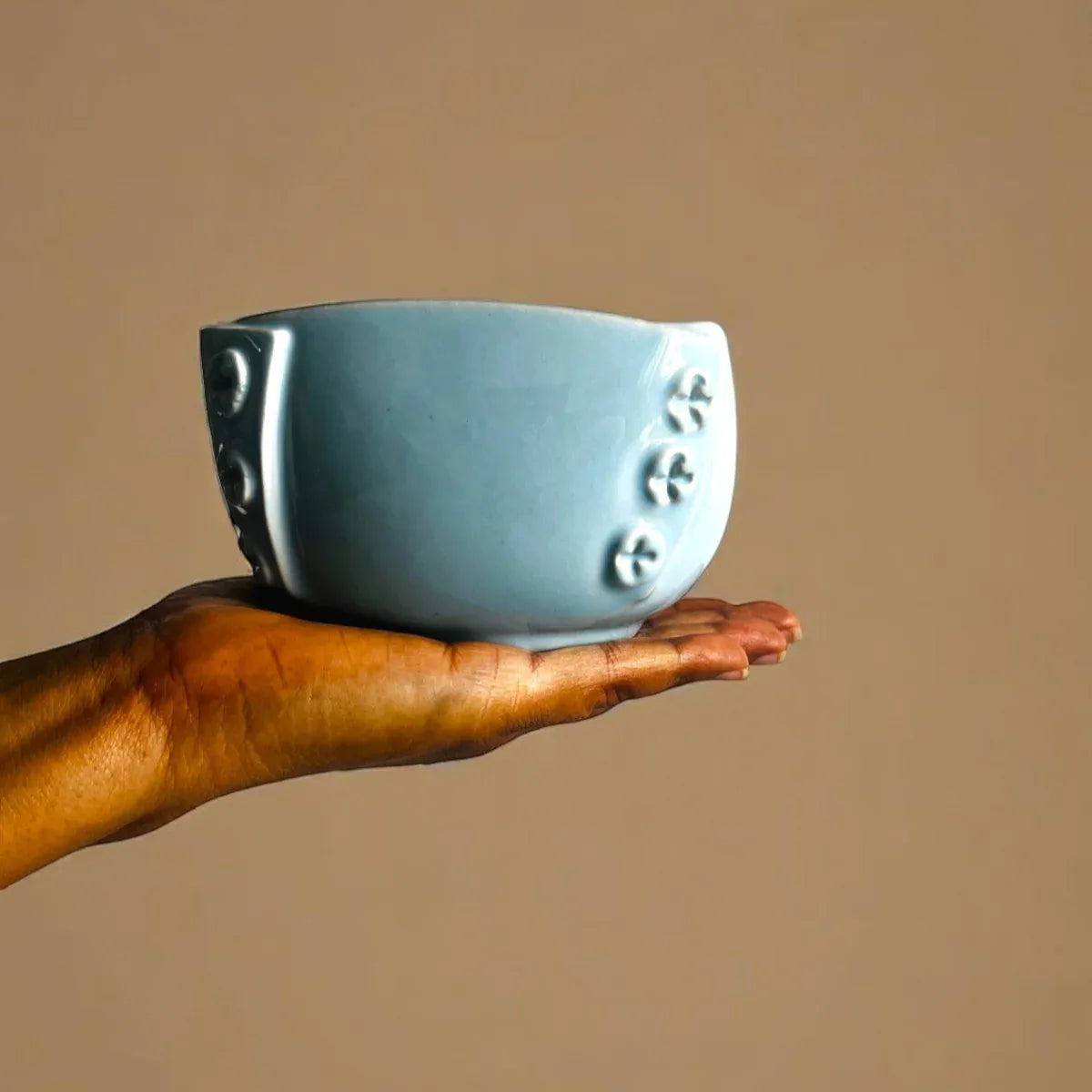 Texture close-up; highlighting the smooth glossy finish and the subtle gradient shifts of the Sky Mist blue glaze.