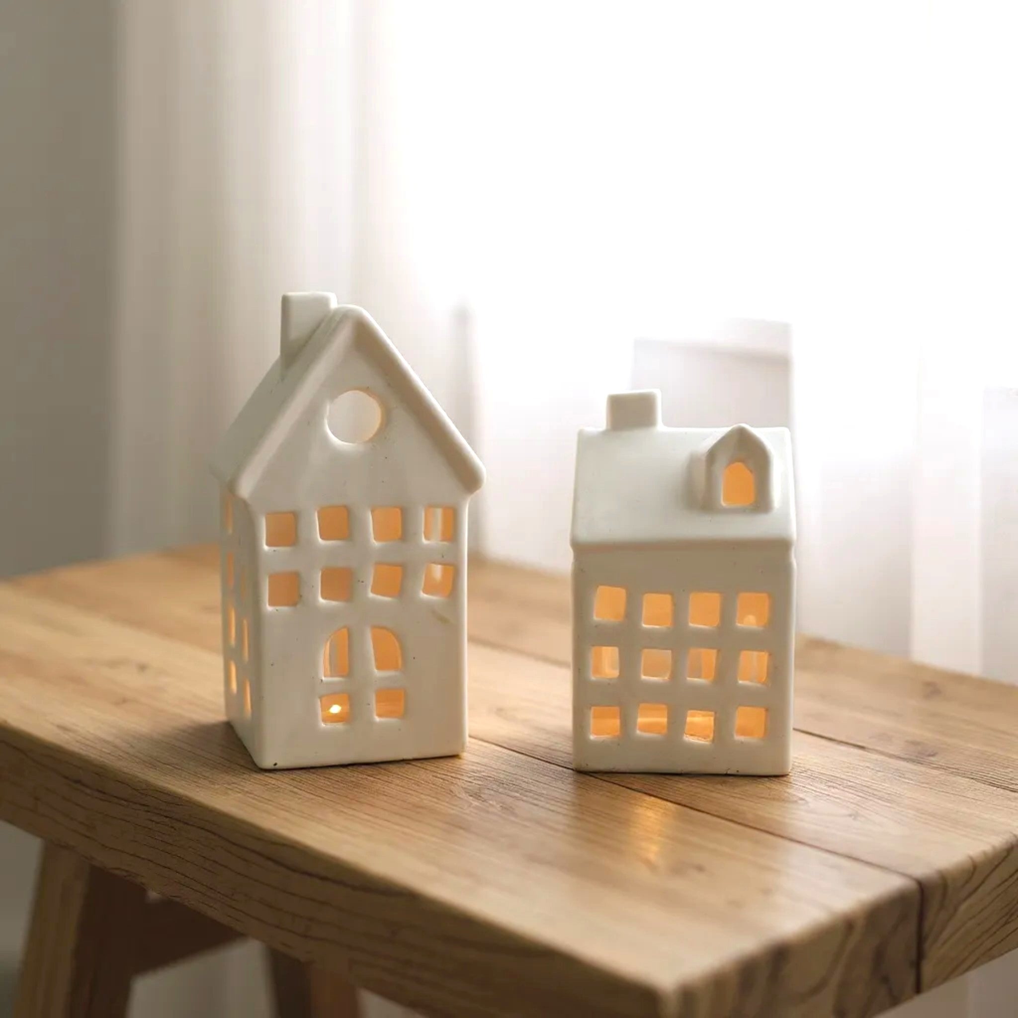 Glow Cottage on table; compact size for tea lights, perfect for bookshelves, nightstands, or windowsills.