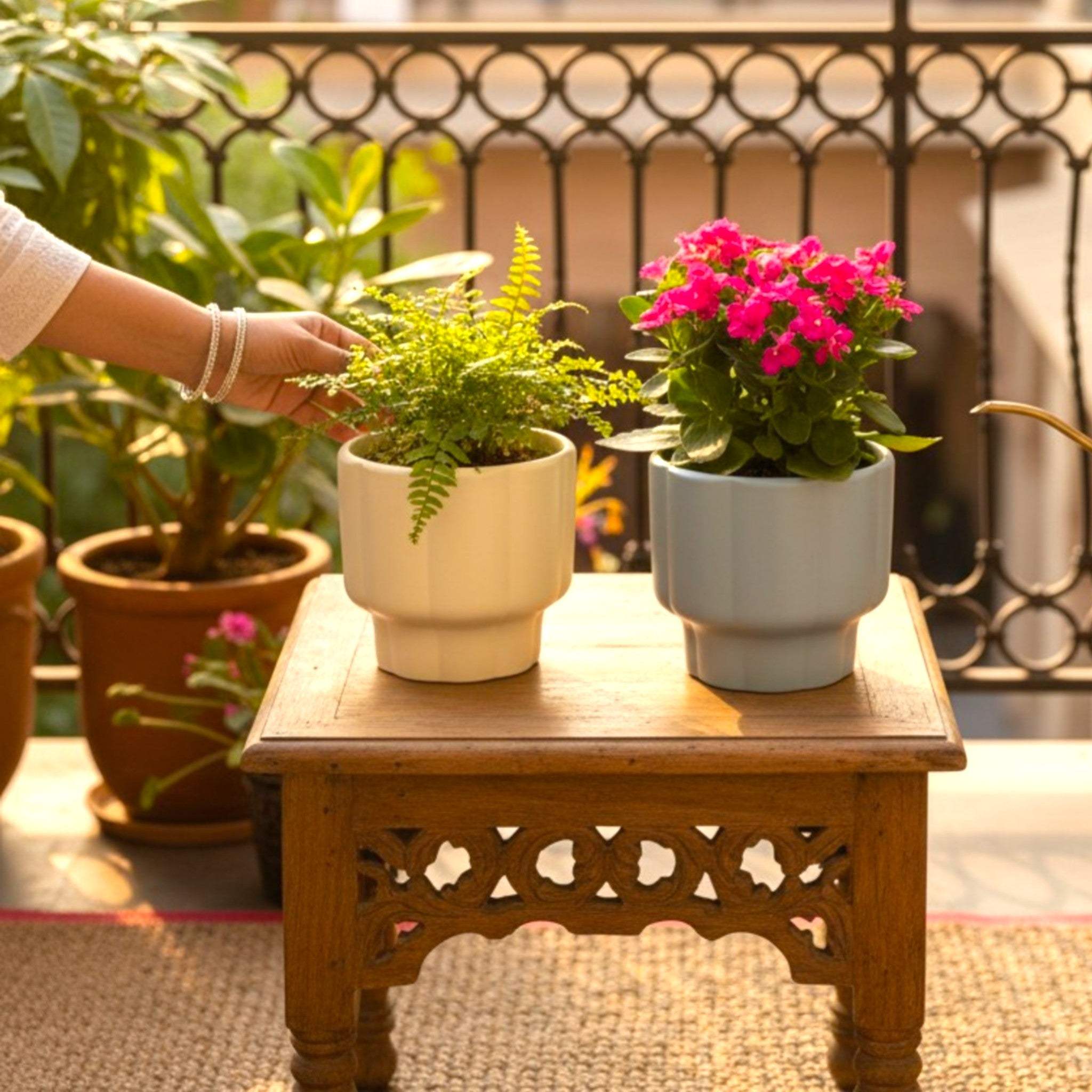 Side-by-side view of Cloud Grey and Buttermilk Yellow planters showcasing the architectural pedestal base.