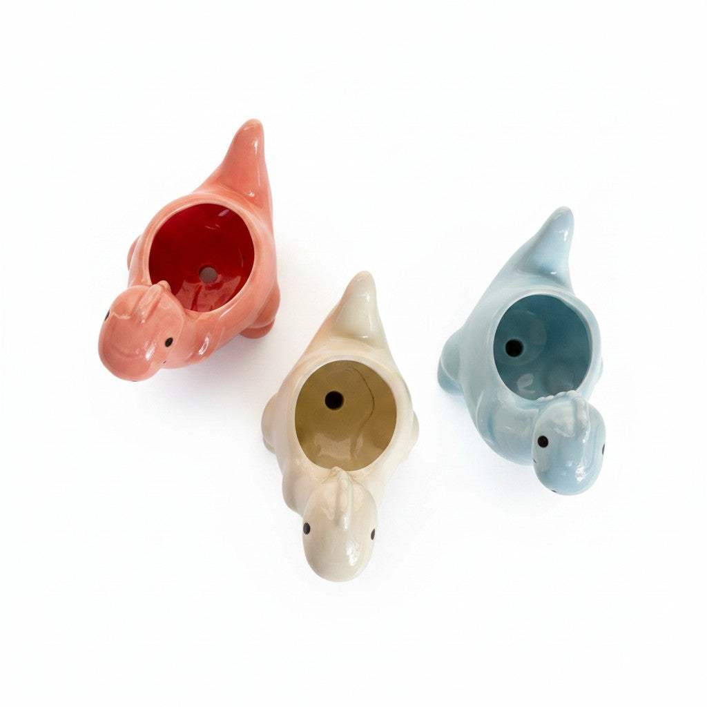 Bottom view highlighting the drainage hole base of the dinosaur ceramic pots for healthy roots.
