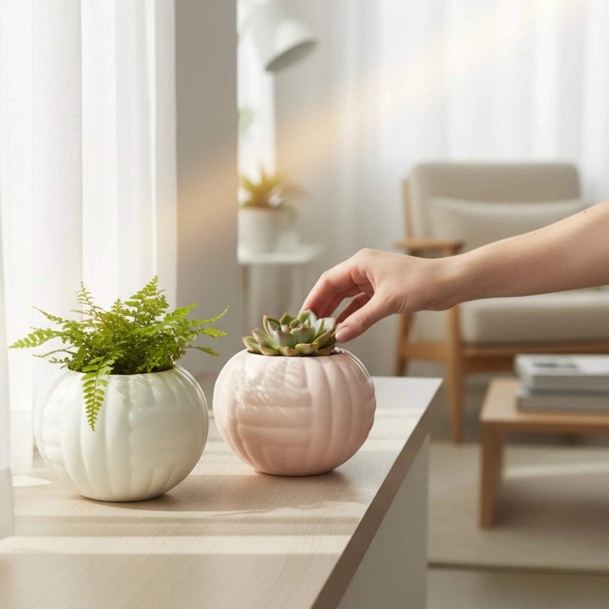 Bright room scene; two ceramic pots in gentle pink and white tones styled together on a sunlit windowsill.