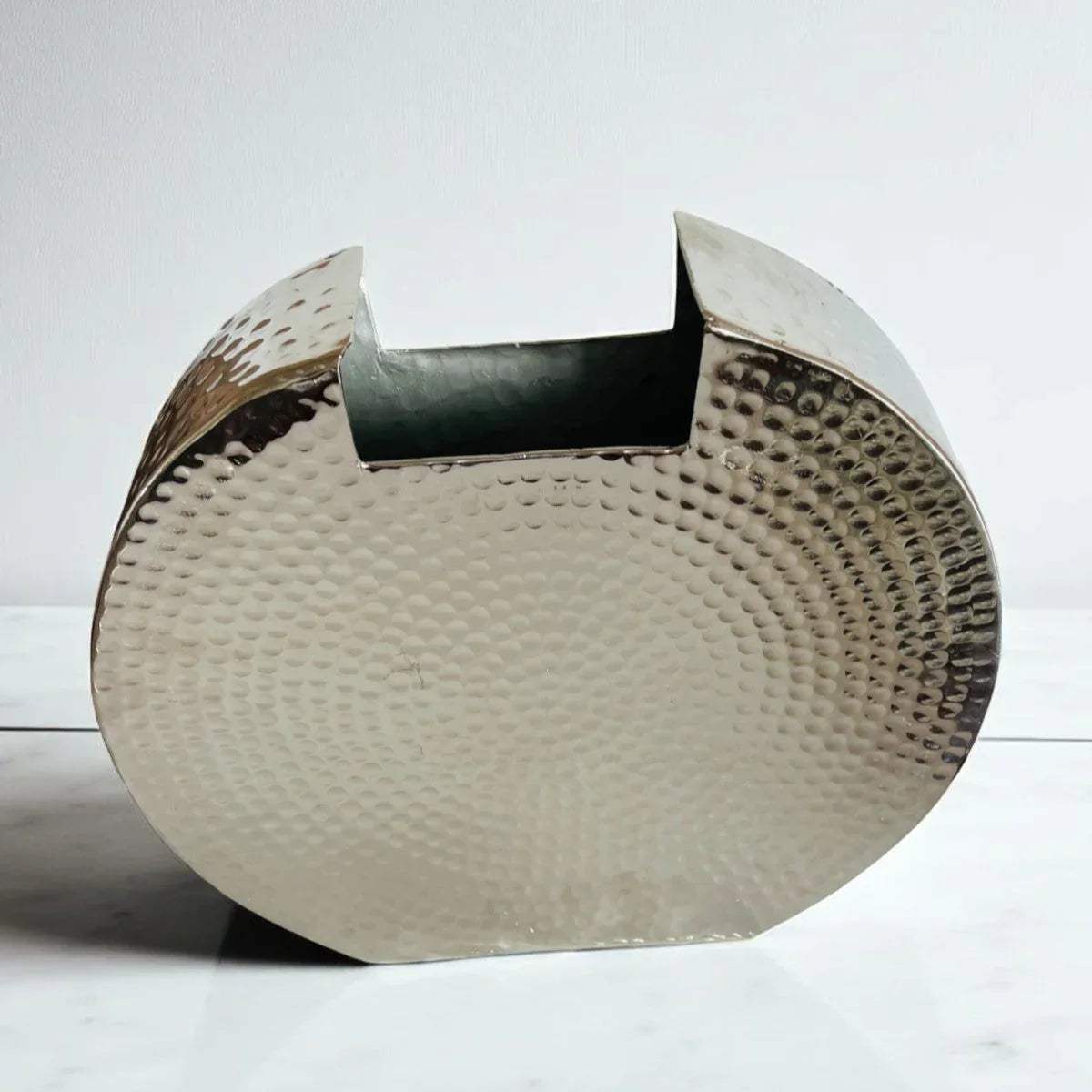 Pitted lunar texture; close-up of the reflective silver metallic finish and hand-crafted crater motifs.