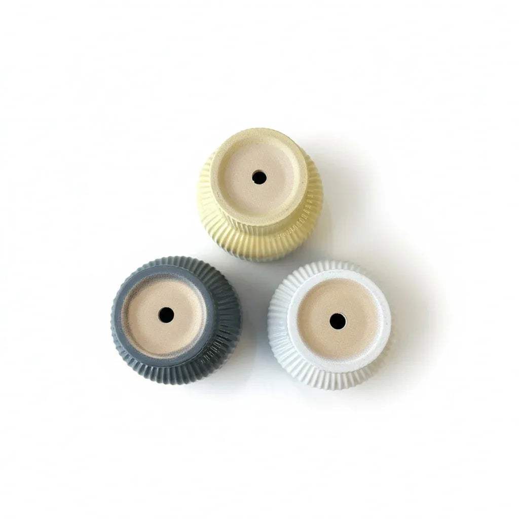 Drainage holes for ceramic balcony planters in soothing pastel shades.