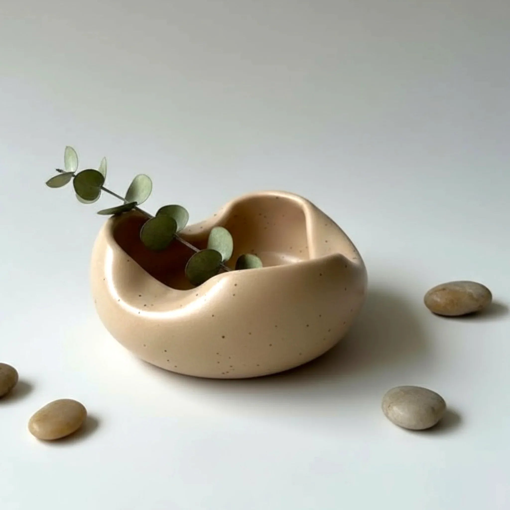 Texture macro; showing the matte, stone-like finish and the subtle artisanal speckles in the high-fired clay.