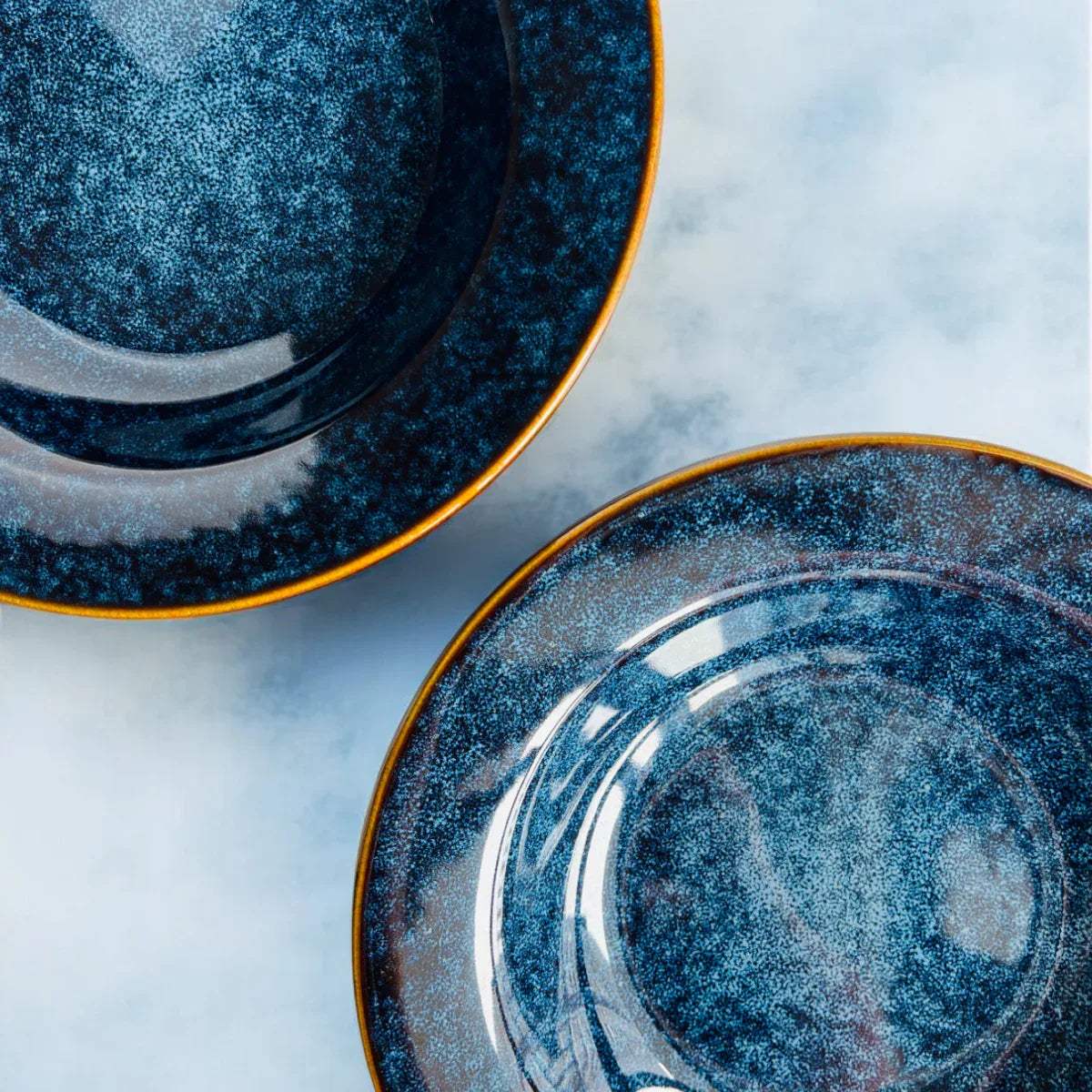 Close-up of starry night glaze; deep midnight blue ceramic with handcrafted white artisanal speckles.