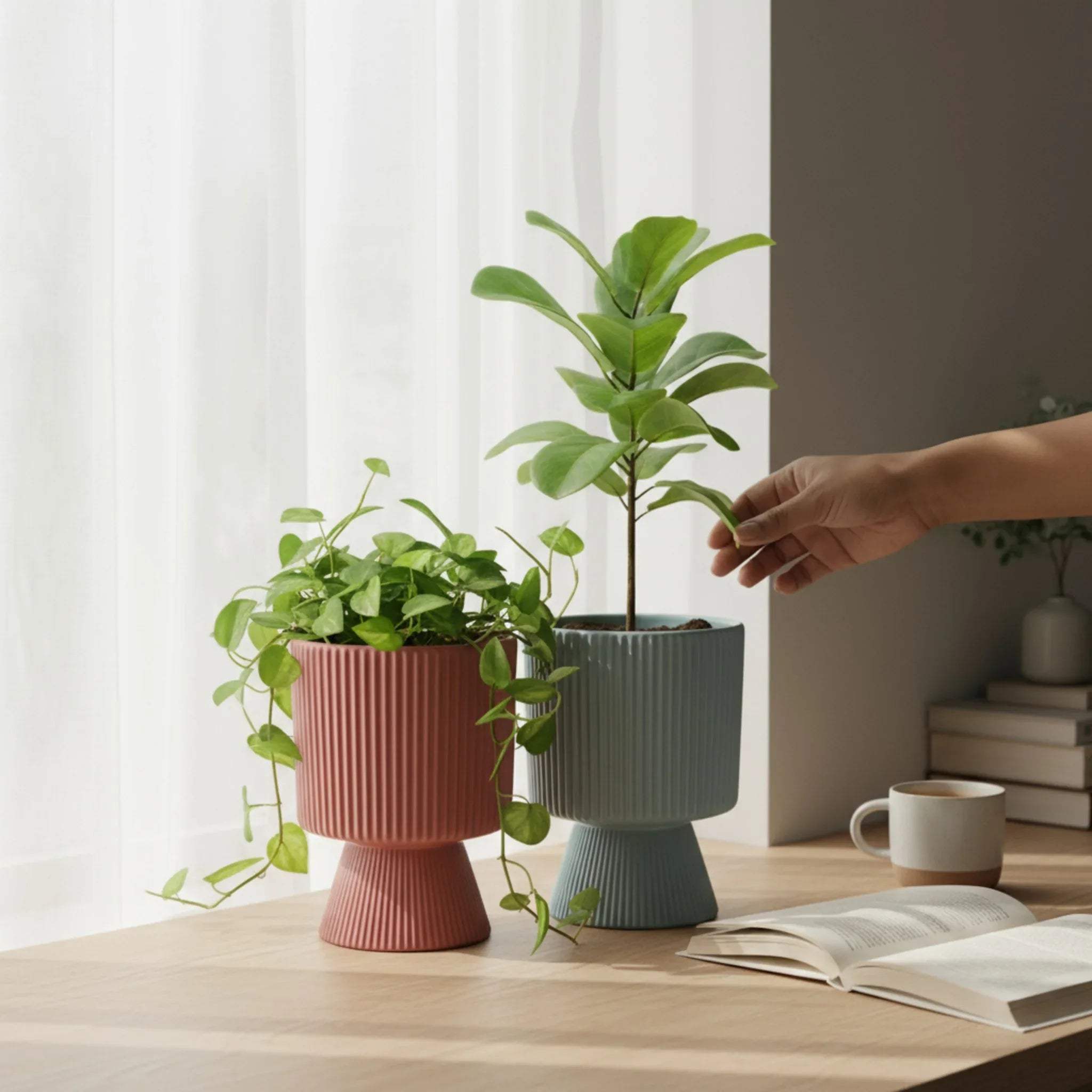 Modern living room; the red and grey planters styled with lush green succulents on a light wood console table.