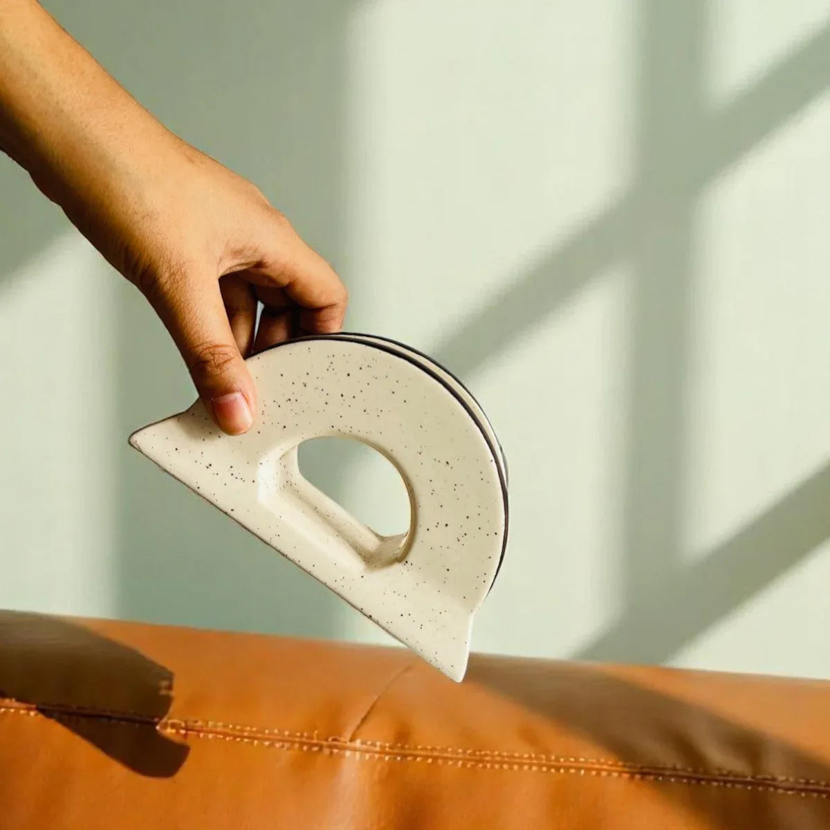 Hand holding the tissue holder; standard size ideal for rectangular tissues and bedside table organization.