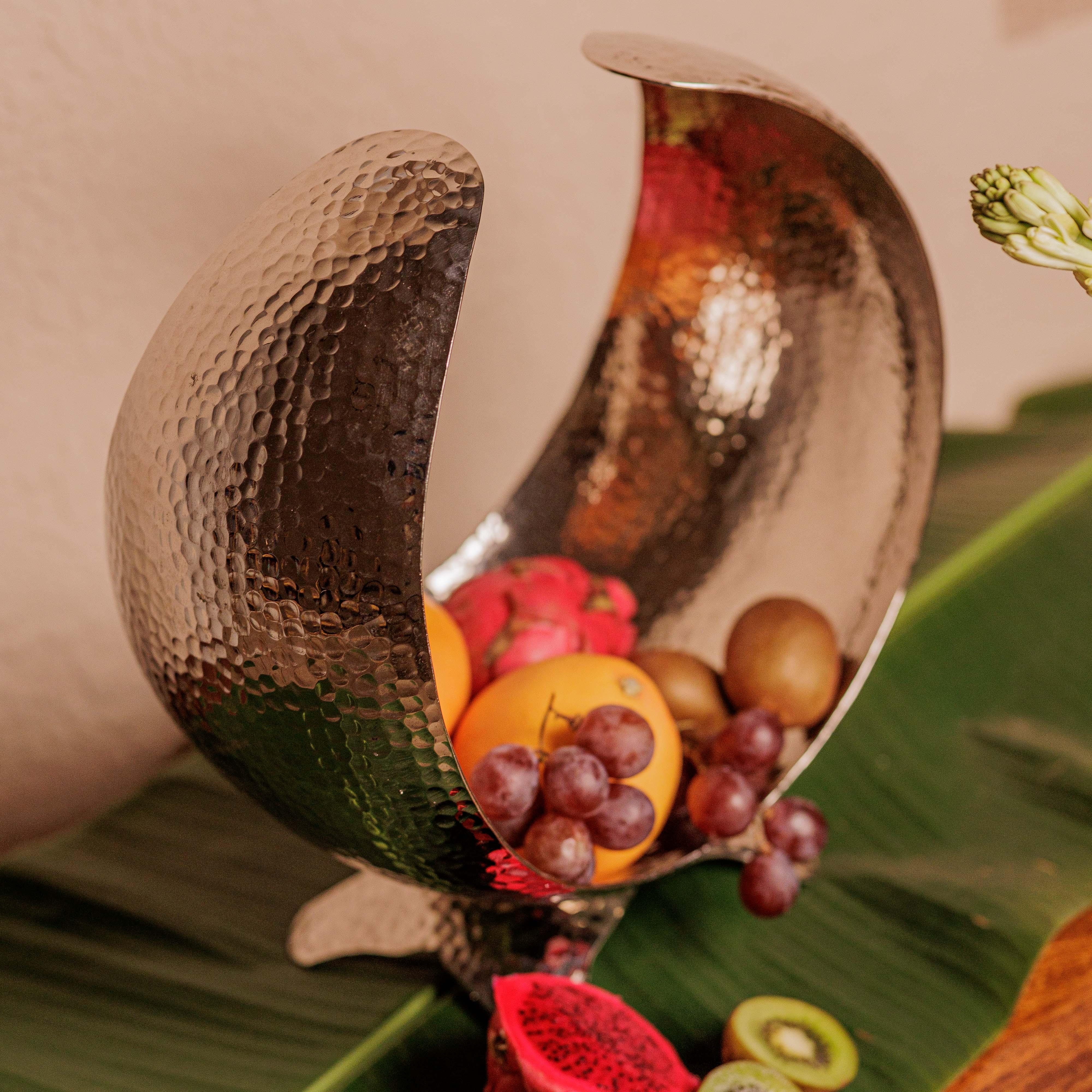 Hand-hammered texture; close-up of the reflective silver aluminium finish and artisanal crescent moon silhouette.