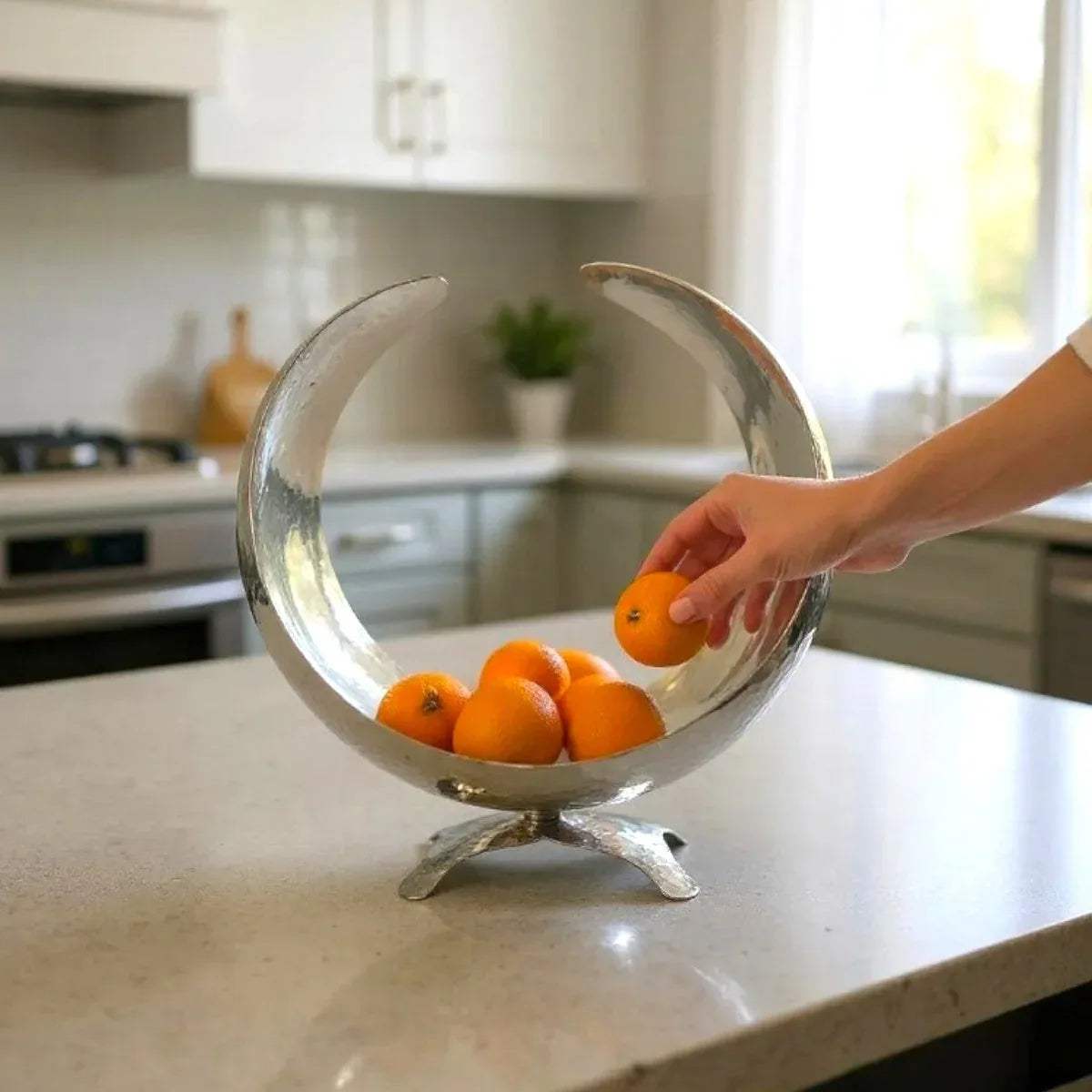 Hands taking an orange from the bowl; 12.5-inch diameter ideal for large fruit assortments, snack serving, or standalone display.
