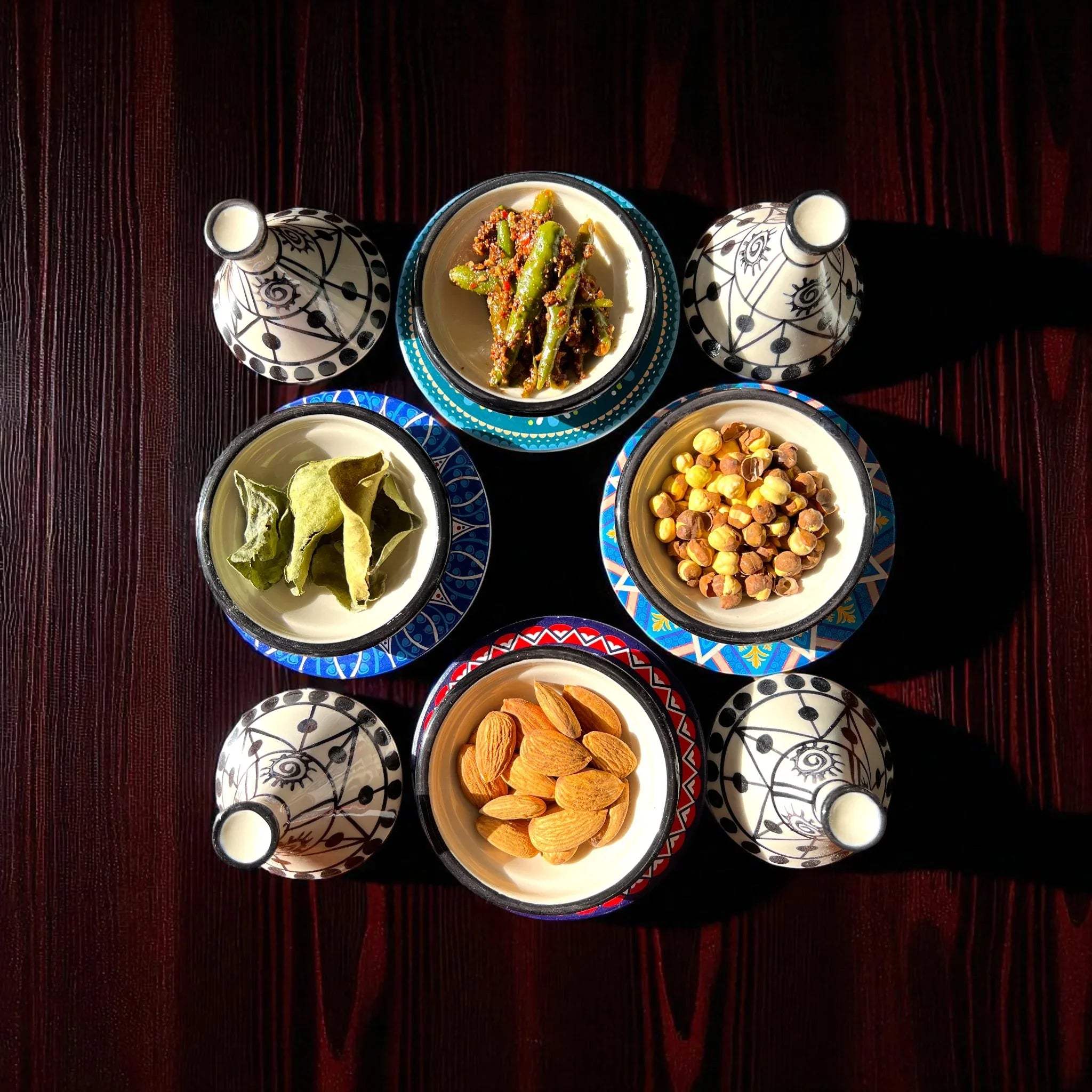 Mini tagines on a charcuterie board; Pinterest-worthy tapas discovery and aesthetic Moroccan hosting ideas.