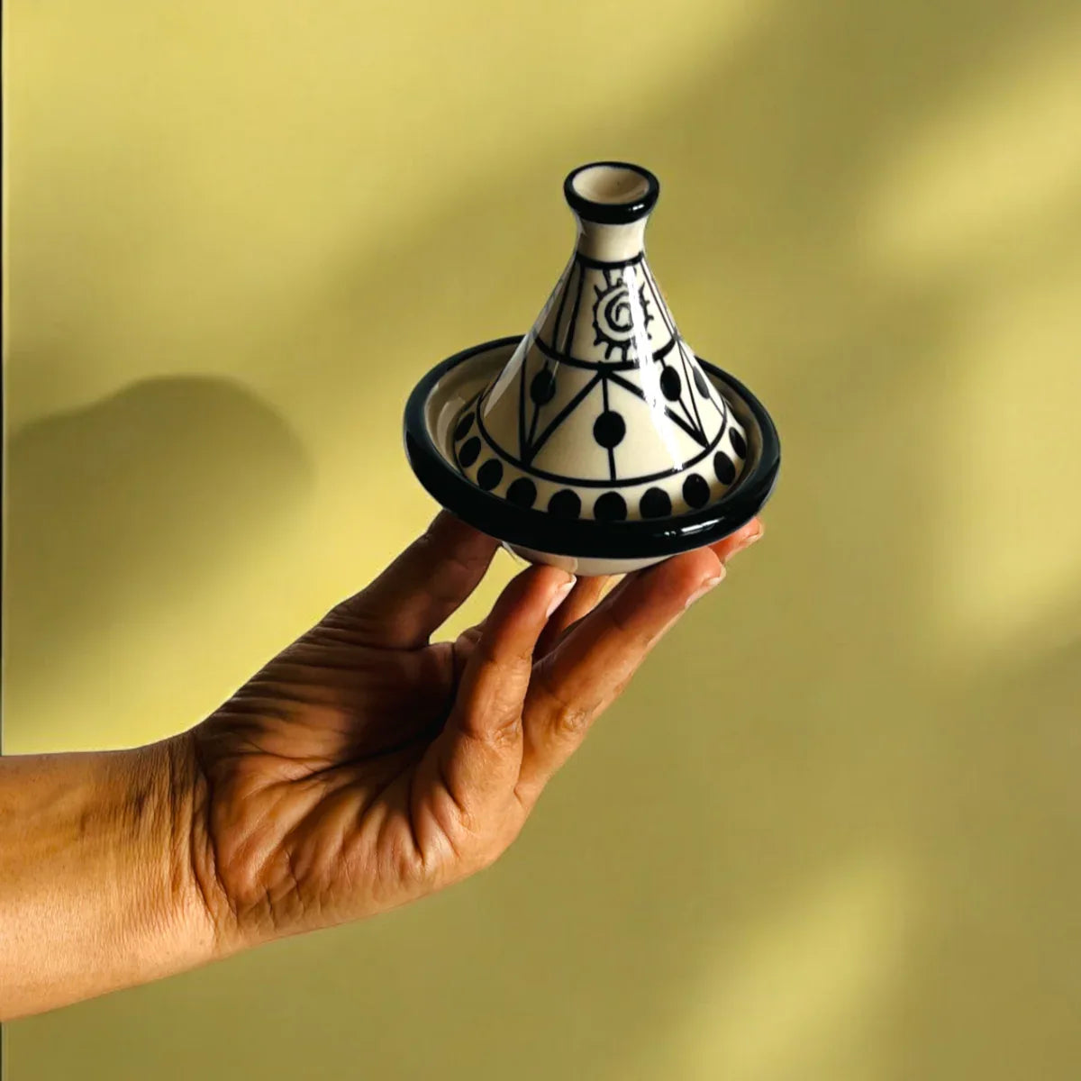 Mini tagine held in hand; 3.2-inch diameter ideal for individual dipping sauces, condiments, or small desserts.