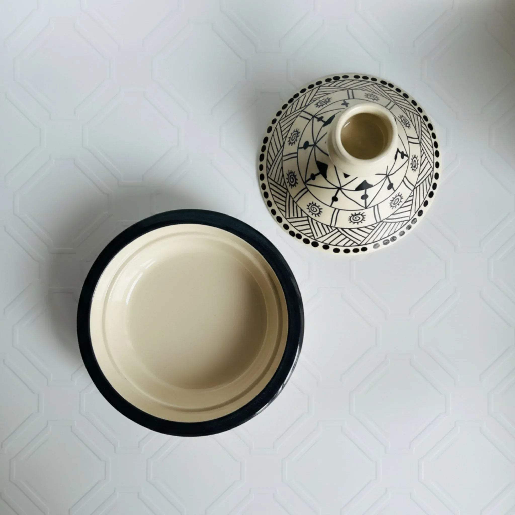 Top view of hand-painted Moroccan patterns; close-up of the glossy black and white artisanal glaze and conical lid.
