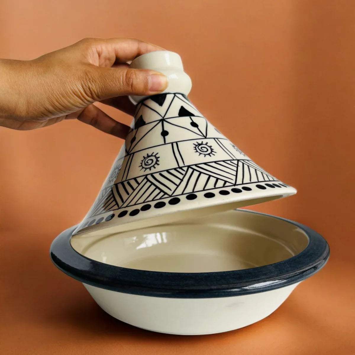 Tagine lid held with a hands; 8.5-inch diameter ideal for family-style serving of stews, salads, or breads.