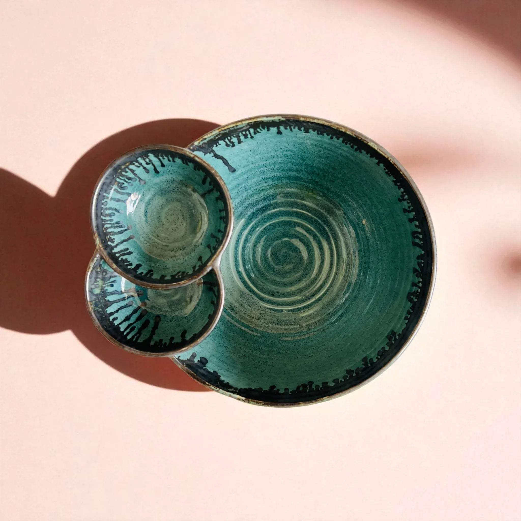 Top view of the bowl; handcrafted ceramic ridges finished in a glossy, wave-like ocean blue glaze.