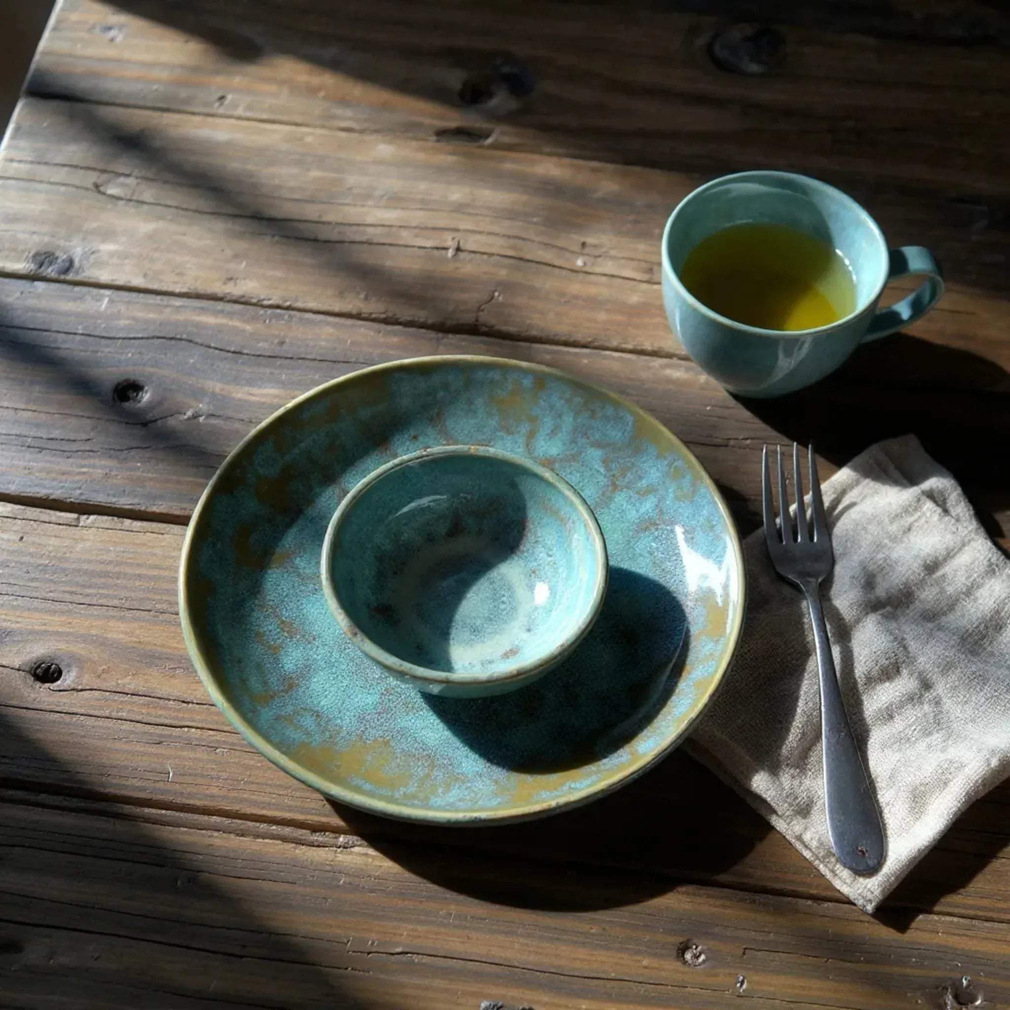 Close-up of "Oceanstone" texture; handcrafted reactive glaze mimicking the organic patterns of coastal stones.