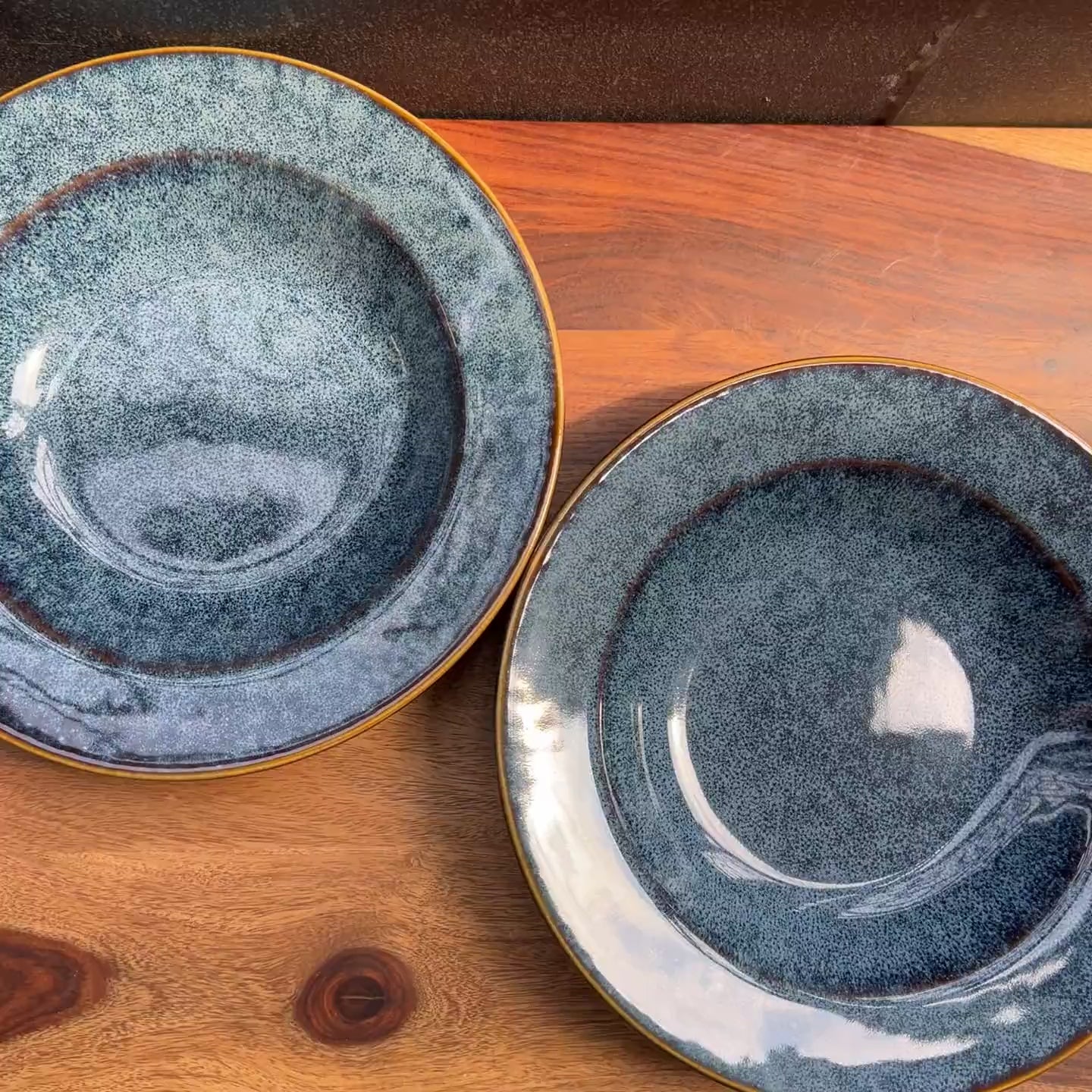 Product video of blue ceramic pasta plates / bowls; reactive glaze.