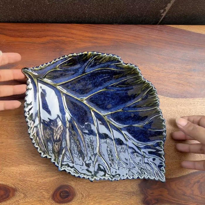 Product video of blue ceramic leaf with detailing of the leaf veins.