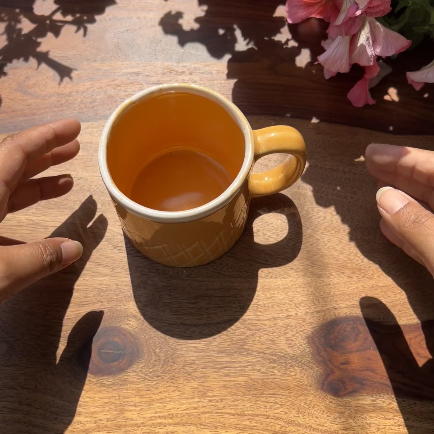 Product video of a yellow ceramic mug with waffle like pattern.