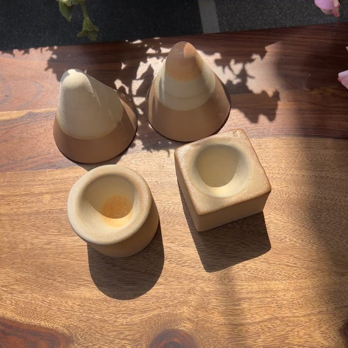Product video of brown ceramic espresso set with a triangle cup and a circle or square base.