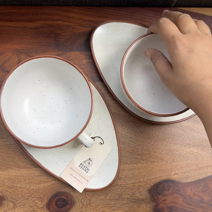 Product video of white ceramic soup cup with saucer with a brown border.
