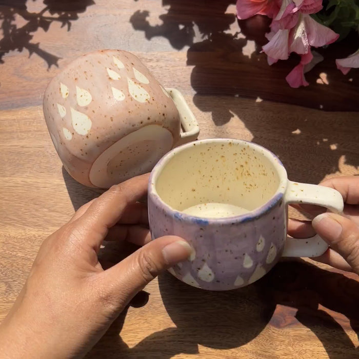 Product video of 2 ceramic cups in pink and purple with raindrops design.