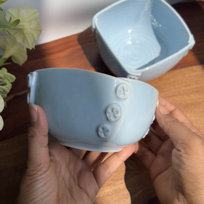 Close up view of the blue handcrafted ceramic bowls with button design, made in India.