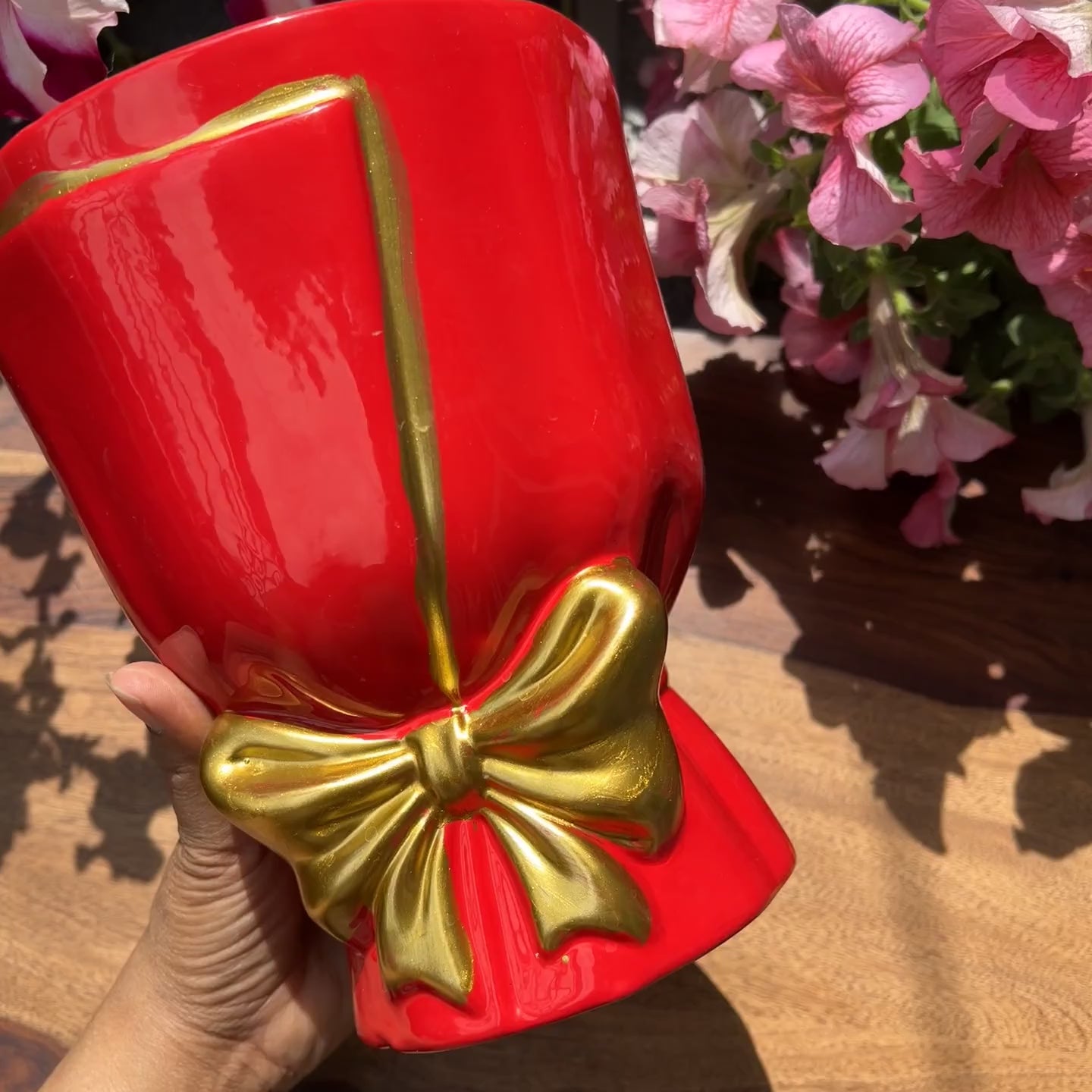 Product video of bouquet shaped planters in red with gold bow detailing; drainage roots and unglazed interior for healthy roots. 