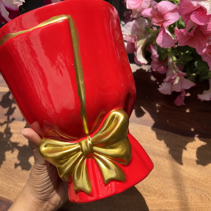 Product video of bouquet shaped planters in red with gold bow detailing; drainage roots and unglazed interior for healthy roots. 