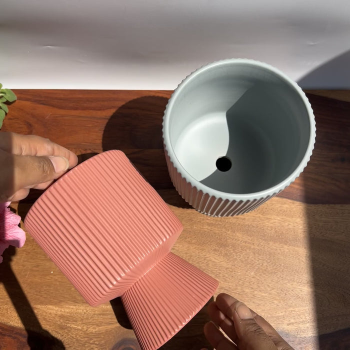 Product video of scarlet and slate planters showing the ribbed detailing in smooth matte colours of red and grey.