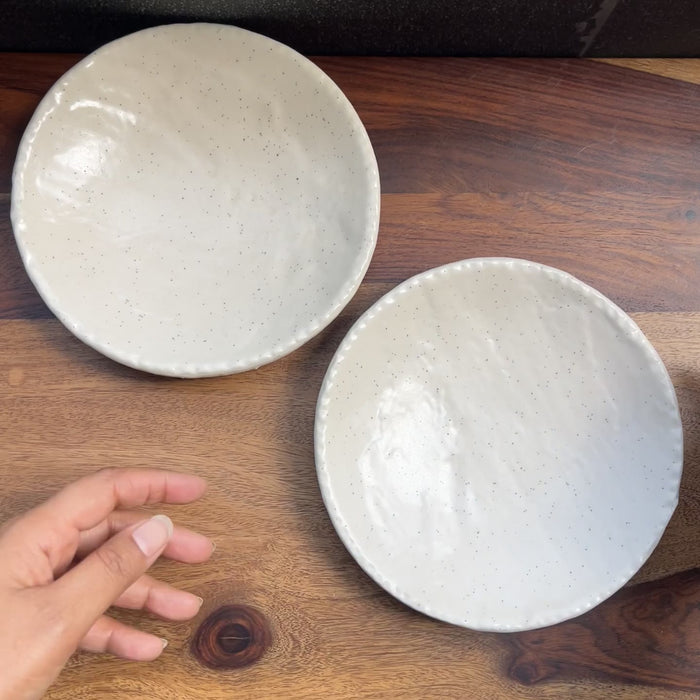 Product video of a ceramic white speckled small plate, perfect for appetiser.